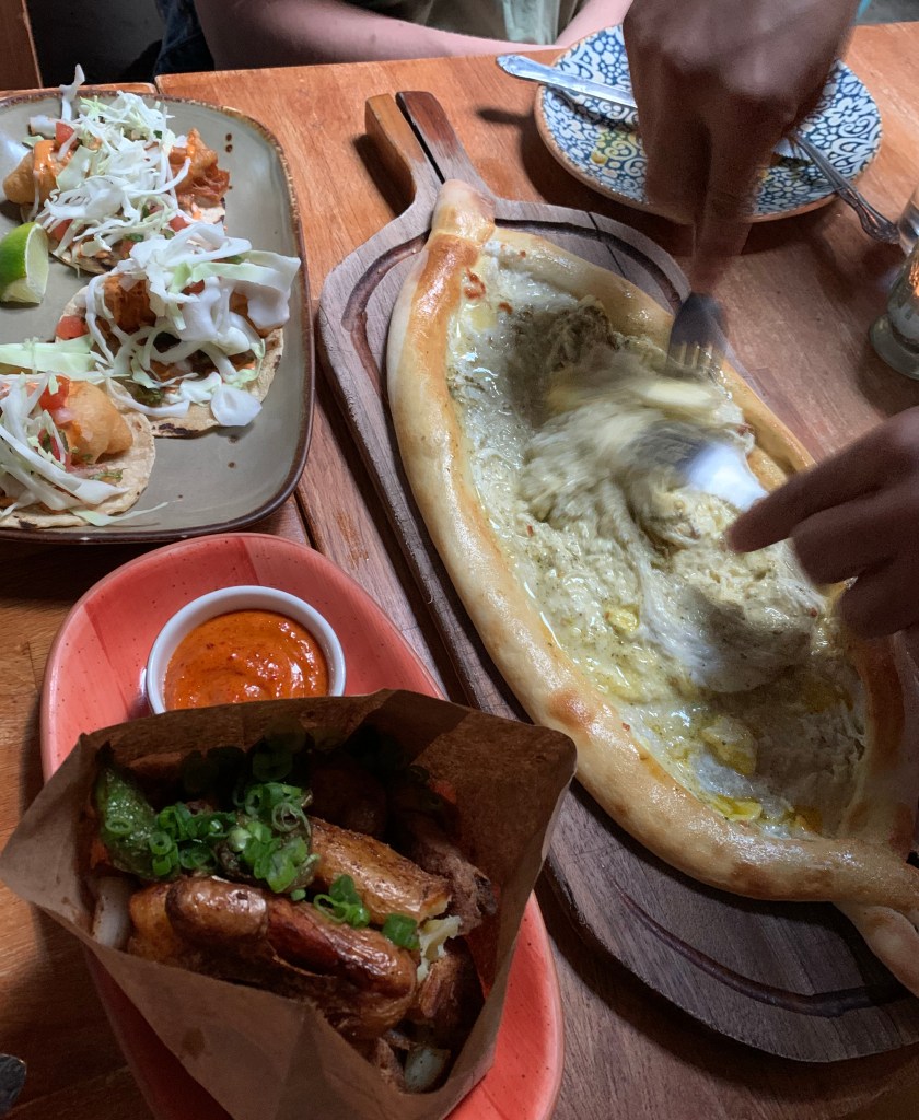 a man mixing an egg and cheese on bread