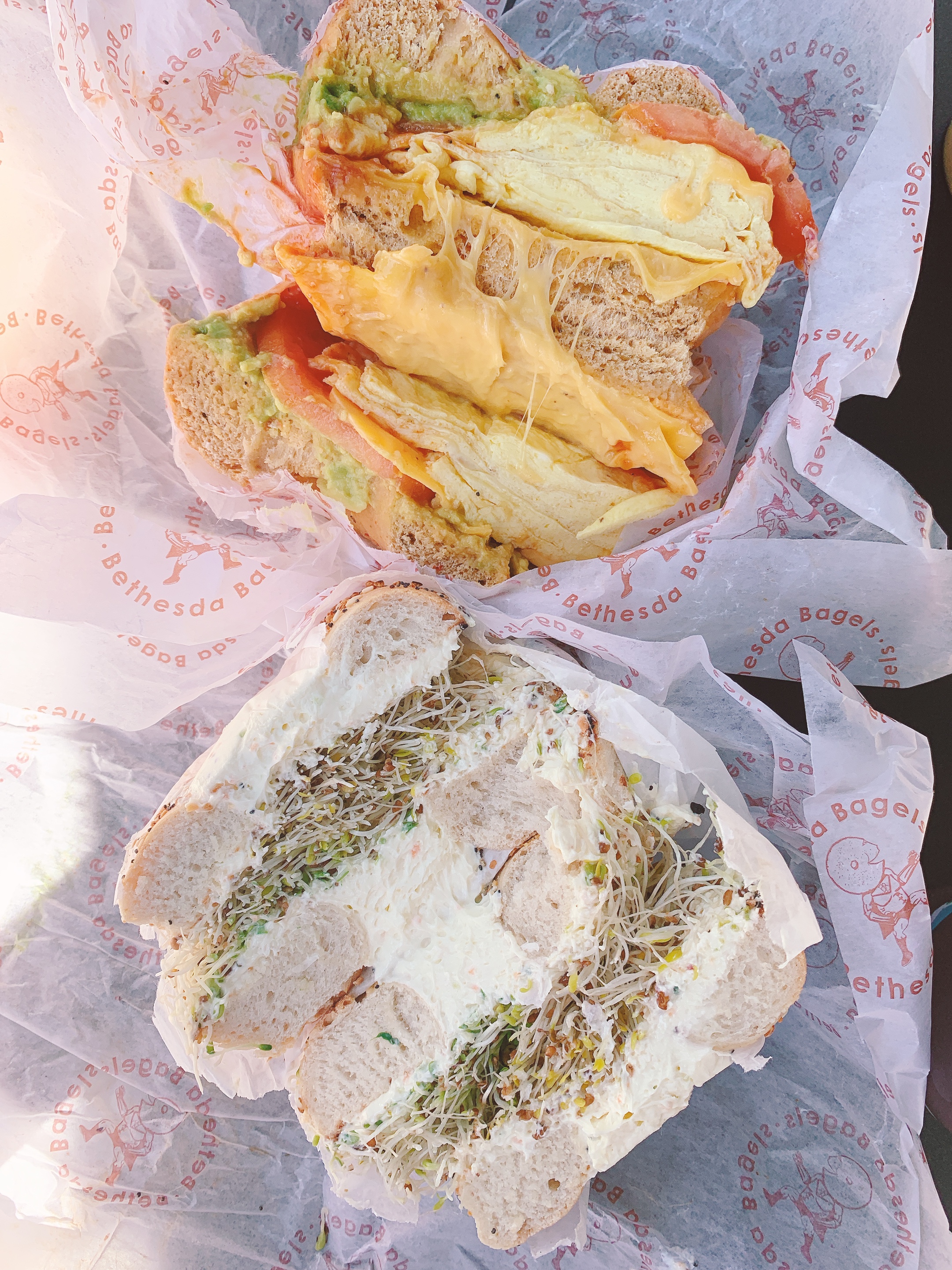 egg and cheese bagel plus cream cheese and scallion bagel